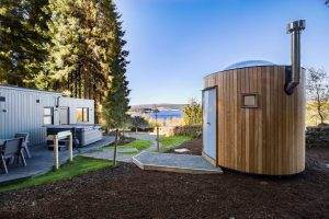 Beech Platinum Stars at Kielder Waterside. View of the single story lodge with stargazing pod in view.